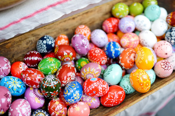 Fototapeta na wymiar Colorful handmade wooden Easter eggs sold in annual traditional crafts fair in Vilnius