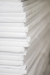 Closeup view. Stacks of large format paper, industrial paper, Reams of white paper in printing factory.