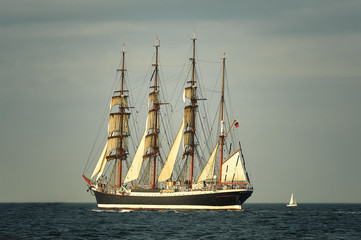  Tall Ship under sail with the shore in the background