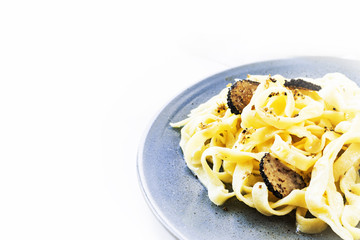 Italian cuisine - taglliatelli with black truffle, copy space.