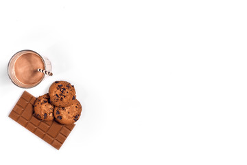 Chocolate milk with cookies on blue background with space for text or design. Top view