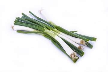 fresh green onions isolated on a white surface