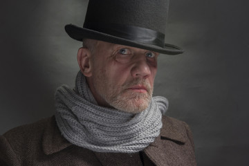 Mature man in period costume outfit with a top hat and grey scarf