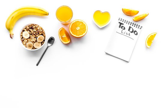 Morning habits of successful people. Healthy breakfast porridge with fruits and planning the day. White background top view copy space