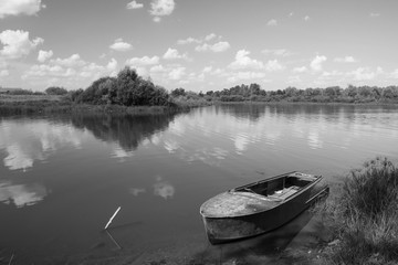 Boat near by coast on background sky