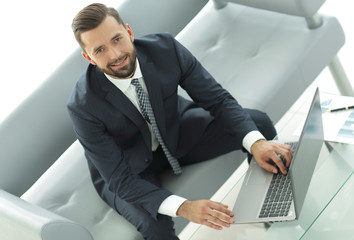 Top view of businessman working on laptop in office