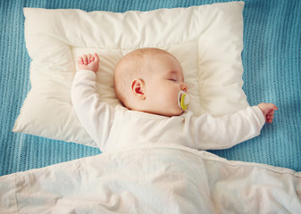 baby sleeping on blue blanket