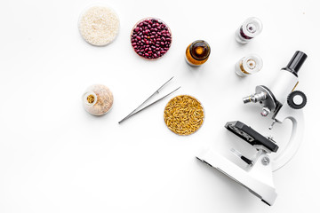 Food safety. Wheat, rice and red beans near microscope on white background top view copy space