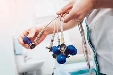 Doctor with electrocardiogram equipment making cardiogram test
