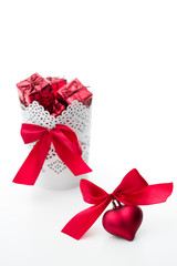 gift and heart with a bow of red color on a white background