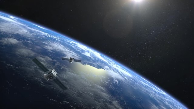 Two satellites scan and monitor the Earth. Satellites appear in the frame and slowly fly away. The Earth's horizon is turned to the right. 4K.