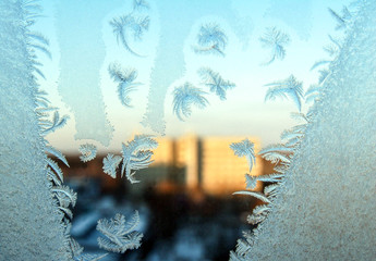 Snowflakes ice pattern on winter window glass