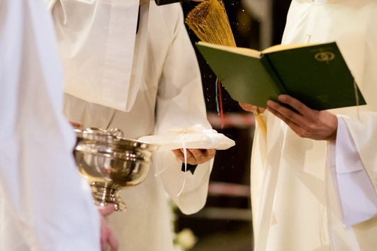 Prist blessing wedding rings in church