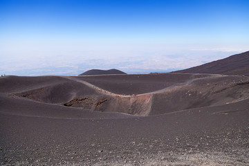 Fototapeta na wymiar The volcano of Etna, Sicily, Italy. Large crater and hiking trail
