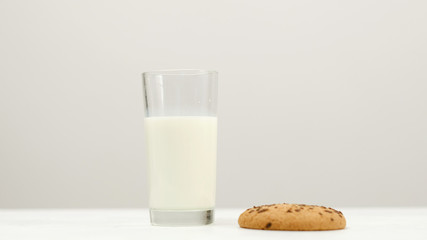 Glass of milk and oatmeal cookie - a tasty snack before going to sleep. Healthy evening food