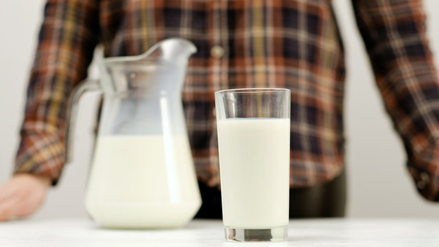 Glass full of milk on white background. Organic dairy. Natural healthy drink. Calcium and vitamin D