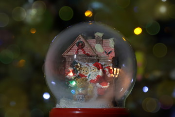 Glass snow globe with Santa Claus and lantern. Christmas toy