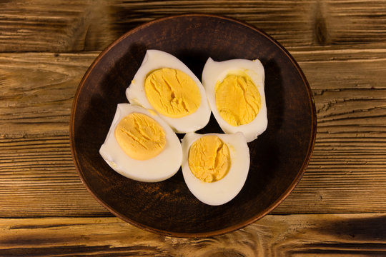 Boiled eggs on a plate on wooden table