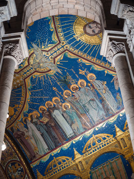 Columns and mosaic ceiling with sacred images inside the sacre-coeur church in the Montmartre district, Paris.