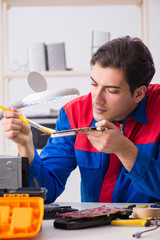 Fototapeta premium Professional repairman repairing computer in workshop