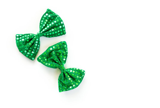 2 bright green bow ties with sequins for St. Patrick's Day isolated on white