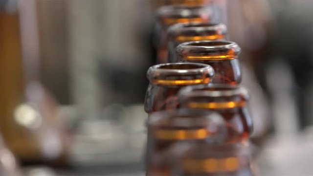 Automatic Beer Bottling Line. Queue of empty bottles on the conveyor.