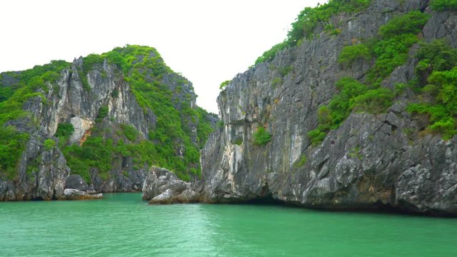 . A beautiful green bay at the island in Vietnam. Popular tourist route. Vietnam. Beautiful open spaces of Vietnam. Walk by the boat. Aerial view