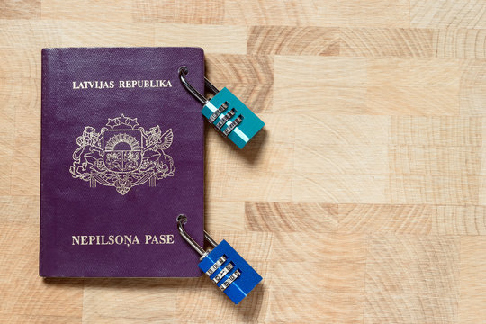 Latvian alians purple passport locked with combination locks, concept