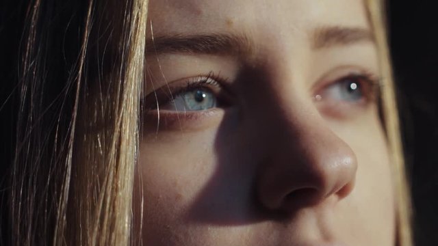 close up shot face young lonely sensual virgin european blue eyes girl room look morning sun light deep breathes hair on wind calm atmosphere