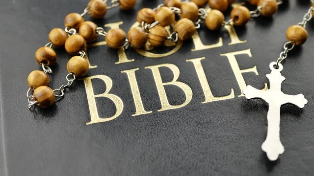 Holy bible and cross on wooden chain