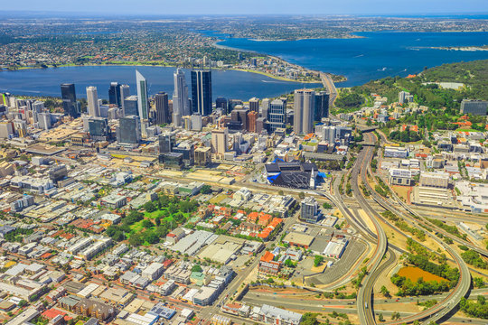 Aerial view of Perth Downtown and Skyline in Australia. Scenic flight over Bell Tower, Narrows Bridge, Swan River, Kings Park, Mill Point, Perth Convention and Exhibition Center in Western Australia.