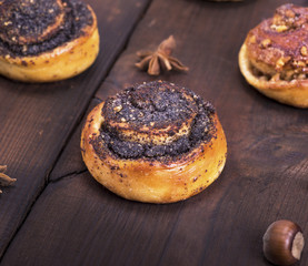 round poppy and nut buns on a brown wooden table