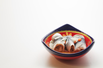 Fototapeta na wymiar roll mop herring in colourful bowl on white background