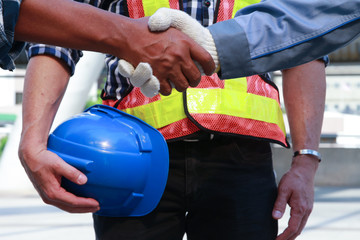  teamwork engineering concept, business cooperate with hands partnership agreement concept  Safety First with holding blue helmet background