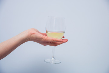a glass of champagne in a female hand
