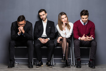 Business People Are Getting Bored While Sitting On Chair Waiting For Job Interview In Office