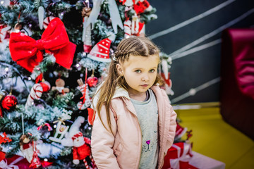Cute baby posing at the Christmas tree
