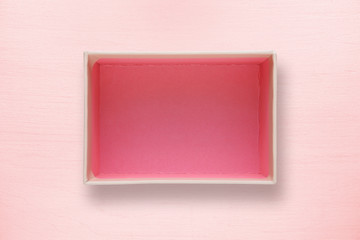 Fototapeta premium Opened box top view on pink background
