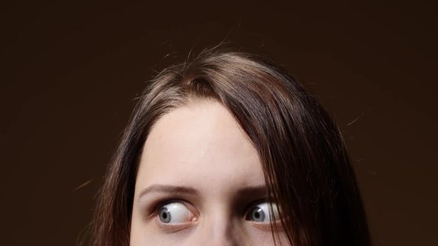 Portrait of a teen girl with a curious suspicious face. Closeup part of a face.