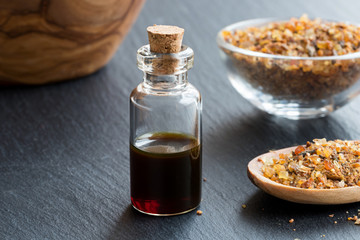 A bottle of myrrh essential oil with myrrh resin