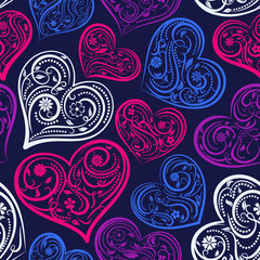 Seamless pattern of big hearts with ornament of curls, flowers and leaves, colored on dark blue