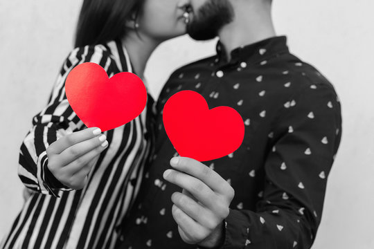 Love Background. Black And White Photo Of Couple In Love With Two Red Hearts. Kiss At First Date At Valentines Day. Marriage Proposal