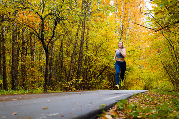 Fototapeta premium Woman running in the autumn park