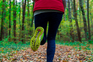 Woman running in the autumn park