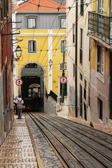 Fototapeta na wymiar Inclined street in Lisbon and Bica Elevator rails