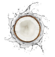 Coconut is surrounded by a splash of water on white background © Krafla