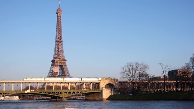 Sunset over Metro crossing Passy bridge with Eiffel Tower in background - Paris, France