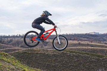 Fototapeta na wymiar Professional cyclist jumping on a mountain bike, a free space.