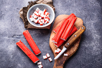 Crab sticks surimi and knife © Yulia Furman