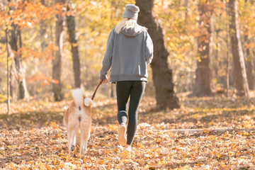 Jogger and akita dog outdoors